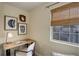 Cozy room featuring a wooden desk, comfortable chair, decorative artwork, and a window with natural light for workspace at 12281 E Tennessee Dr # 302, Aurora, CO 80012