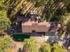Overhead shot of a home with mature tree coverage, multiple decks, and a three-car garage at 612 Nob Hill Trl, Franktown, CO 80116