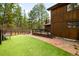 A manicured backyard features a grassy area, wood deck, and mature trees at 612 Nob Hill Trl, Franktown, CO 80116