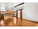 Spacious dining area with a large island, sliding doors, and wood-look flooring at 612 Nob Hill Trl, Franktown, CO 80116