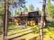 Large wood sided house with multiple decks, patios, and large windows at 612 Nob Hill Trl, Franktown, CO 80116