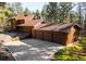 Charming wooden home featuring a three-car garage and a lush, forested surrounding at 612 Nob Hill Trl, Franktown, CO 80116