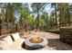 A relaxing outdoor fire pit features comfortable seating and views of the surrounding trees at 612 Nob Hill Trl, Franktown, CO 80116