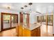 Bright kitchen area with an island, wood cabinets, and sliding doors to the deck at 612 Nob Hill Trl, Franktown, CO 80116