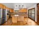Well-lit kitchen featuring stainless steel appliances, wood cabinets and a center island at 612 Nob Hill Trl, Franktown, CO 80116