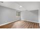 A bright and spacious room with wood floors and a window looking out onto a treed lot at 612 Nob Hill Trl, Franktown, CO 80116