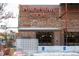 The Punch Bowl Social building features a brick facade and neon sign, with patio seating visible at 115 W 2Nd Ave # 104, Denver, CO 80223