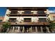Building featuring doors that open and balconies on the upper floors with ornate iron railings at 115 W 2Nd Ave # 104, Denver, CO 80223