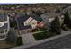 An aerial view of a charming two-story home with a three car garage, complemented by lush landscaping and a well-manicured lawn at 7862 Stonedale Dr, Castle Pines, CO 80108