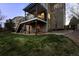 Spacious backyard with grass, patio, and deck at 7862 Stonedale Dr, Castle Pines, CO 80108
