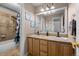 Bathroom featuring double sinks with wood cabinets and neutral countertop at 7862 Stonedale Dr, Castle Pines, CO 80108