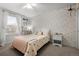 Bedroom featuring a bed, nightstand, and decorative wallpaper at 7862 Stonedale Dr, Castle Pines, CO 80108