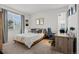 Cozy bedroom with a large window and a dedicated workspace, offering comfort and functionality at 7862 Stonedale Dr, Castle Pines, CO 80108