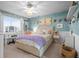 Charming bedroom with blue walls, white trim, and a cozy bed with a lavender blanket at 7862 Stonedale Dr, Castle Pines, CO 80108