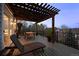 Outdoor patio with lounge chair and pergola-covered dining table at 7862 Stonedale Dr, Castle Pines, CO 80108
