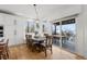 Sunlit dining area with a wooden table, built-in bench seating, and access to an outdoor deck at 7862 Stonedale Dr, Castle Pines, CO 80108