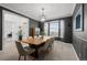 An elegant dining room featuring a wooden table, plush chairs, and a large bay window, perfect for Gathering gatherings at 7862 Stonedale Dr, Castle Pines, CO 80108