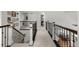 Hallway overlooking a staircase and dining area at 7862 Stonedale Dr, Castle Pines, CO 80108