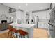 Contemporary kitchen boasting stainless steel appliances, a breakfast bar, and a seamless open layout at 7862 Stonedale Dr, Castle Pines, CO 80108