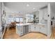 Bright kitchen with white cabinets, stainless steel appliances, and a dining area with large windows at 7862 Stonedale Dr, Castle Pines, CO 80108