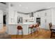 Modern kitchen featuring stainless steel appliances, a breakfast bar, and ample counter space at 7862 Stonedale Dr, Castle Pines, CO 80108