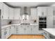 Well-lit kitchen with white cabinetry, stainless steel appliances, and marble countertops at 7862 Stonedale Dr, Castle Pines, CO 80108