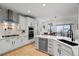 Modern kitchen featuring white cabinets, stainless steel appliances, and hardwood floors at 7862 Stonedale Dr, Castle Pines, CO 80108
