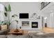 Stunning living room featuring a white brick fireplace, modern decor, and soaring ceilings at 7862 Stonedale Dr, Castle Pines, CO 80108