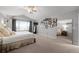 Large main bedroom showcasing neutral carpet, vaulted ceiling, and sliding barn door to bathroom at 7862 Stonedale Dr, Castle Pines, CO 80108