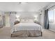 Bright main bedroom with plush carpeting and a comfortable bed with decorative pillows and bedding at 7862 Stonedale Dr, Castle Pines, CO 80108
