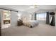 Spacious main bedroom boasting vaulted ceilings, barn door to bathroom, and neutral decor at 7862 Stonedale Dr, Castle Pines, CO 80108