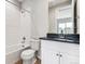 Bathroom features a shower over tub, modern fixtures and a large mirror over the vanity at 1840 Morgan Dr, Erie, CO 80516