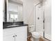 This clean bathroom features a glass shower, toilet, vanity, and hardwood floors at 1840 Morgan Dr, Erie, CO 80516