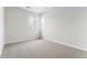 Bright bedroom features neutral carpet and walls, plus a pair of windows at 1840 Morgan Dr, Erie, CO 80516