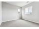 Bright bedroom features neutral carpet and walls, plus a pair of windows that let in ample light at 1840 Morgan Dr, Erie, CO 80516