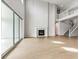 Open-concept living room with fireplace and large sliding glass doors at 1840 Morgan Dr, Erie, CO 80516