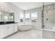 Luxurious main bathroom features a soaking tub, walk-in shower, and dual sink vanity at 1840 Morgan Dr, Erie, CO 80516