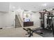 Finished basement with a staircase, custom wet bar, and workout area offering additional living space at 7790 S Queensburg Way, Aurora, CO 80016