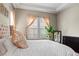 Close-up of a bedroom with a comfortable bed, soft lighting, and neutral decor at 7790 S Queensburg Way, Aurora, CO 80016