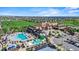 Extensive aerial view of a community with a clubhouse, pool, golf course, and neat neighborhood layout at 7790 S Queensburg Way, Aurora, CO 80016