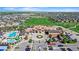 Wide aerial shot of a community featuring a pool, golf course, clubhouse, and surrounding homes at 7790 S Queensburg Way, Aurora, CO 80016
