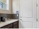 Granite countertop and coffee station next to a convenient white door at 7790 S Queensburg Way, Aurora, CO 80016