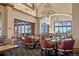 Elegant dining area with stylish seating, chandelier lighting, and expansive windows, perfect for sophisticated gatherings at 7790 S Queensburg Way, Aurora, CO 80016