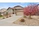 Beautifully landscaped front yard with a stone driveway leading to the attached two-car garage at 7790 S Queensburg Way, Aurora, CO 80016