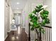 Elegant hallway with hardwood floors, a stylish staircase, and a tastefully decorated interior at 7790 S Queensburg Way, Aurora, CO 80016
