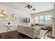 A stylishly furnished living room featuring hardwood floors, a fireplace, and comfortable seating arrangements at 7790 S Queensburg Way, Aurora, CO 80016