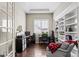 Bright home office with built-in shelving, two work stations and a comfortable sitting area at 7790 S Queensburg Way, Aurora, CO 80016