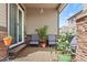 Outdoor patio with comfortable seating, a decorative rug, and a serene ambiance at 7790 S Queensburg Way, Aurora, CO 80016
