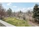 A well-maintained lawn with mature trees provides a serene backdrop for this backyard at 11285 Ranch Pl, Denver, CO 80234