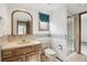 Bathroom featuring single sink vanity, toilet, and glass enclosed shower at 11285 Ranch Pl, Denver, CO 80234